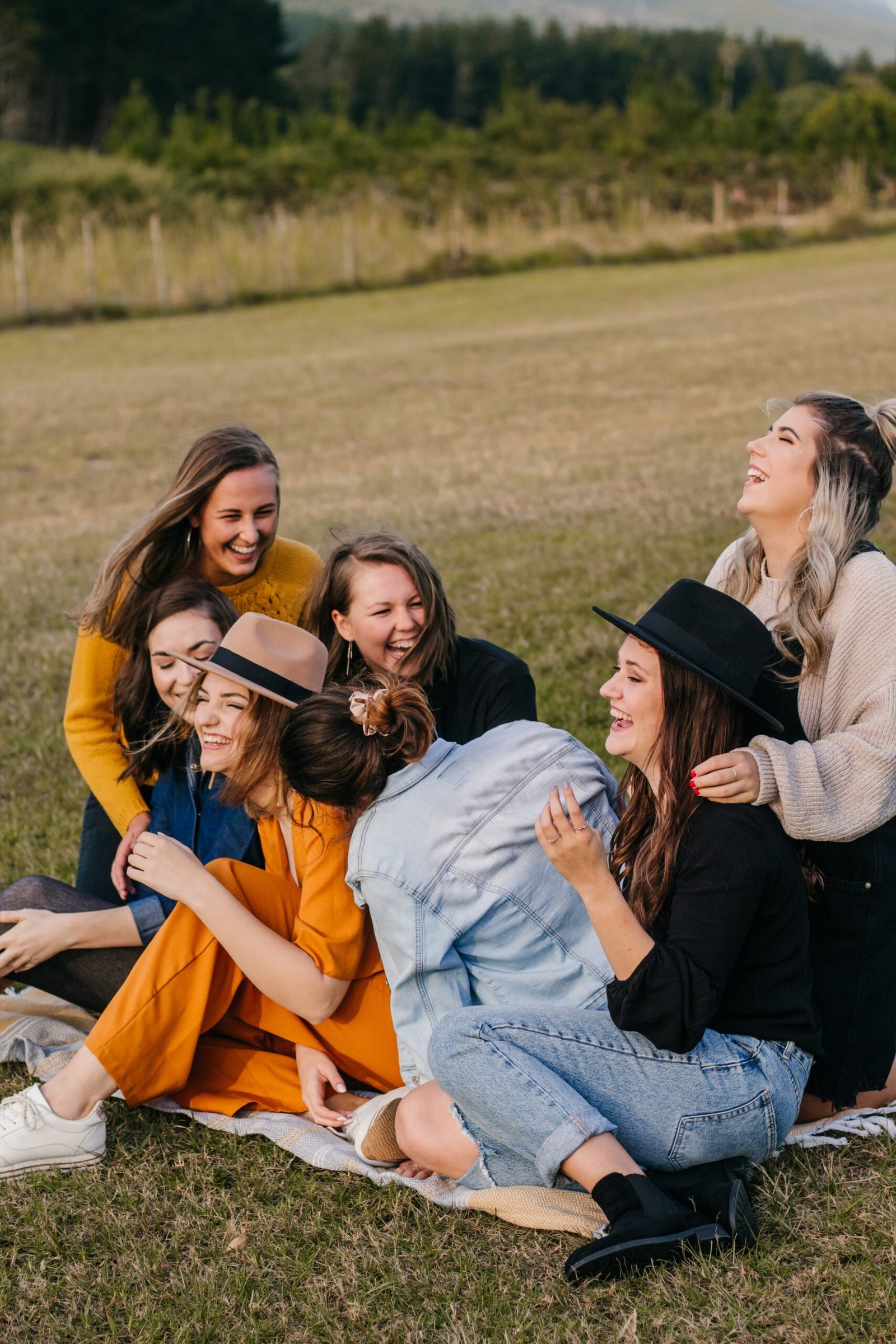 happy women hugging on the grass